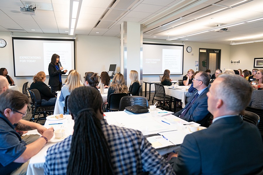 President Mantella and staff in 2019 huddle engagement